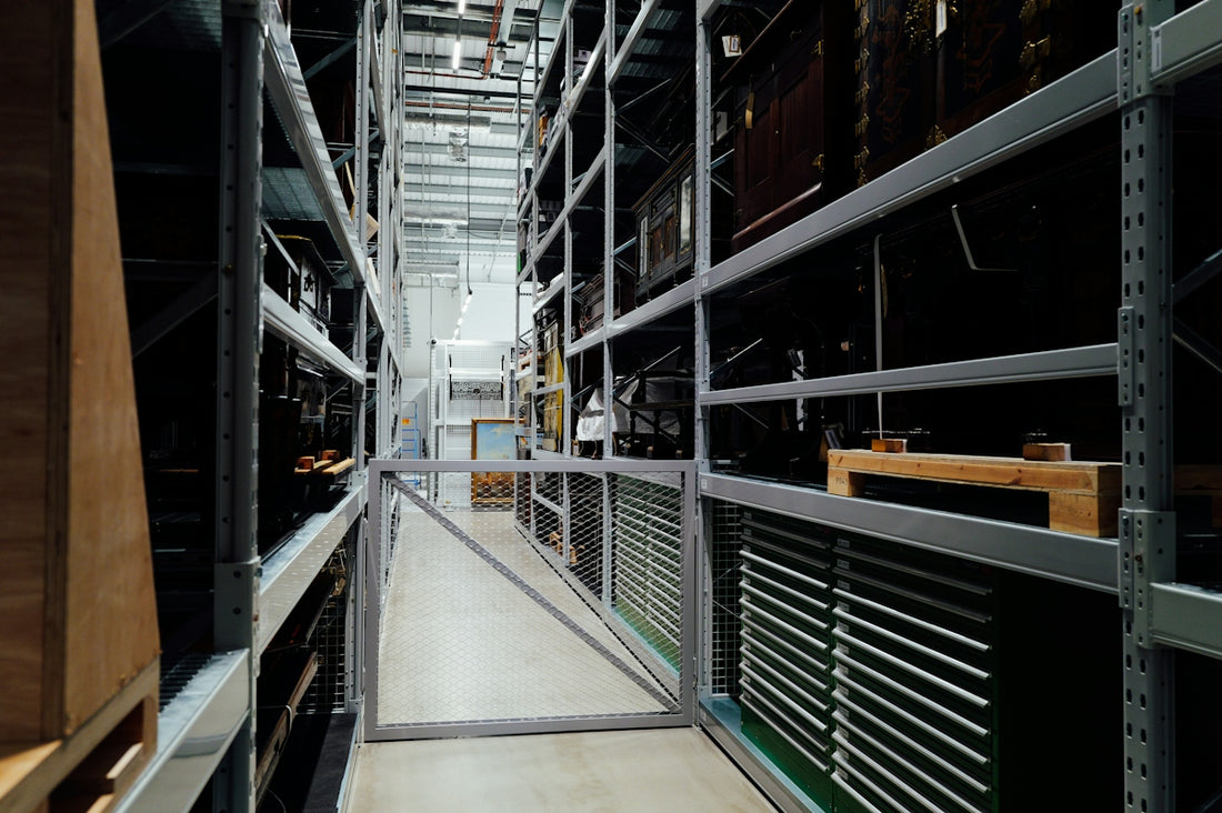 A long aisle between tall storage shelves in a warehouse